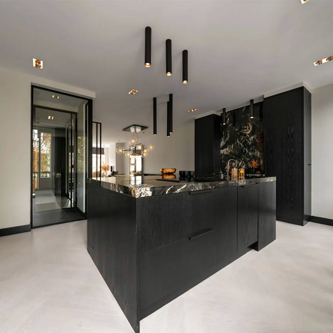 Modern kitchen with black cabinets and marble accents