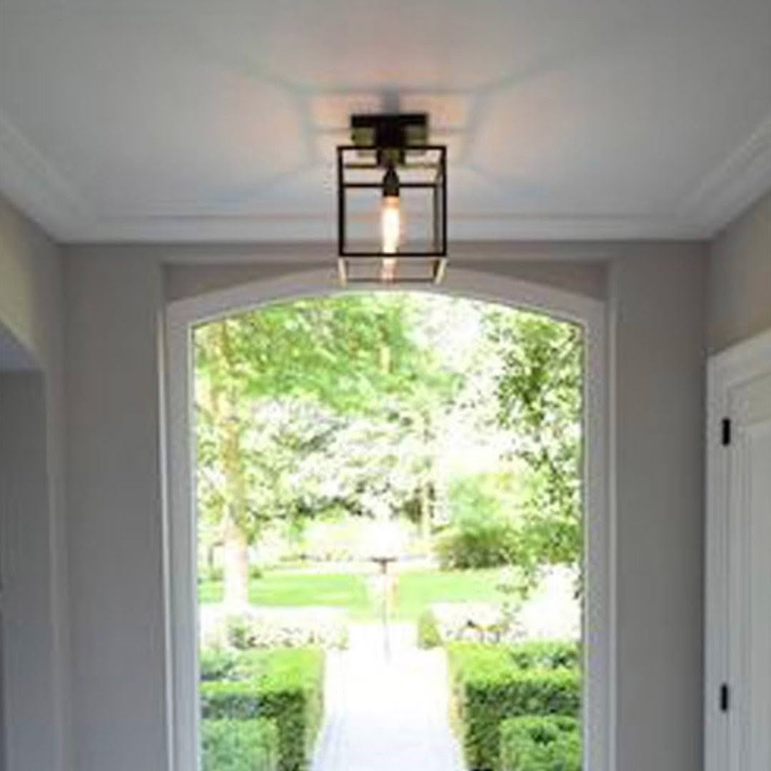Elegant lantern over arched doorway framing garden view