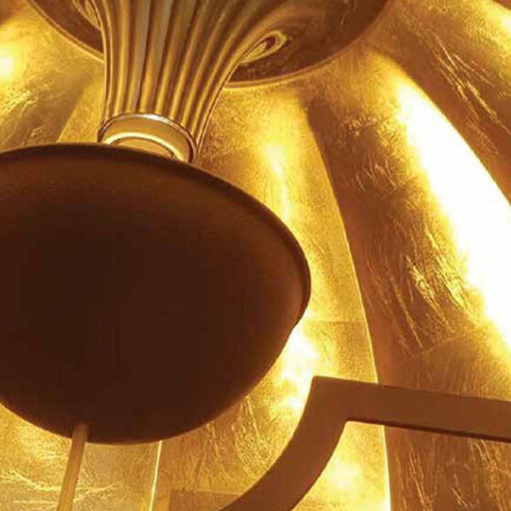 Golden ceiling light detail with reflective surface
