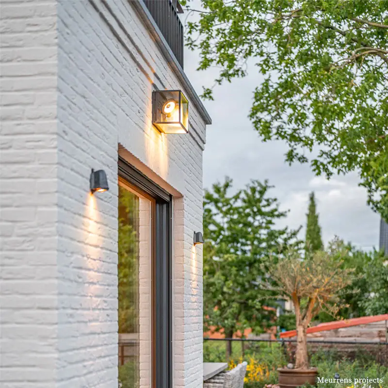 White brick building with modern outdoor lights