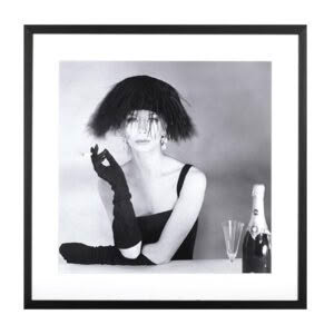 Woman in black dress with shaggy hat smoking