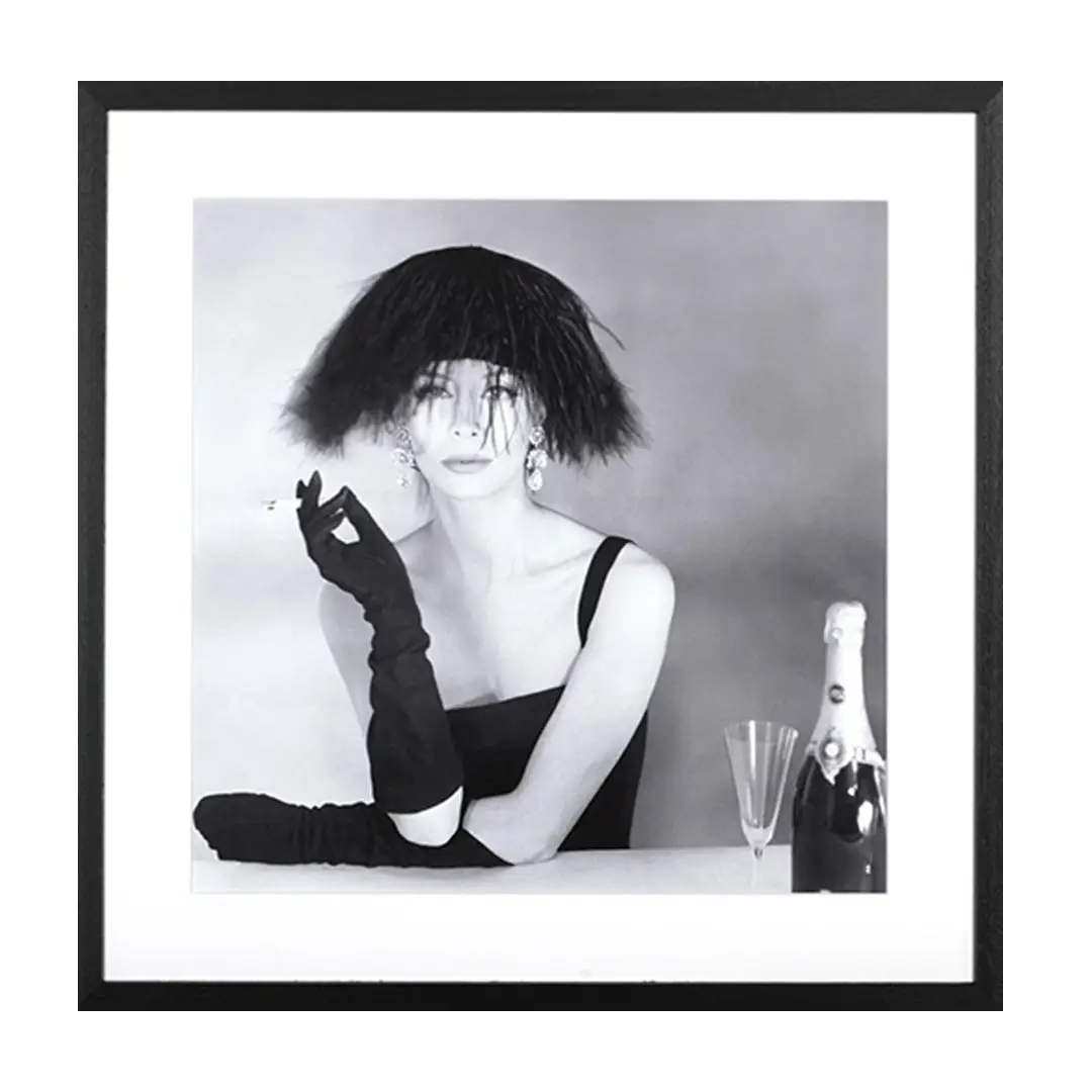 Woman in black dress with shaggy hat smoking