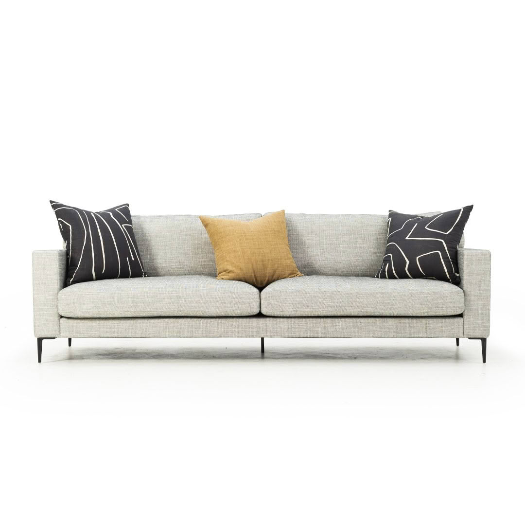 Modern grey sofa with three decorative pillows