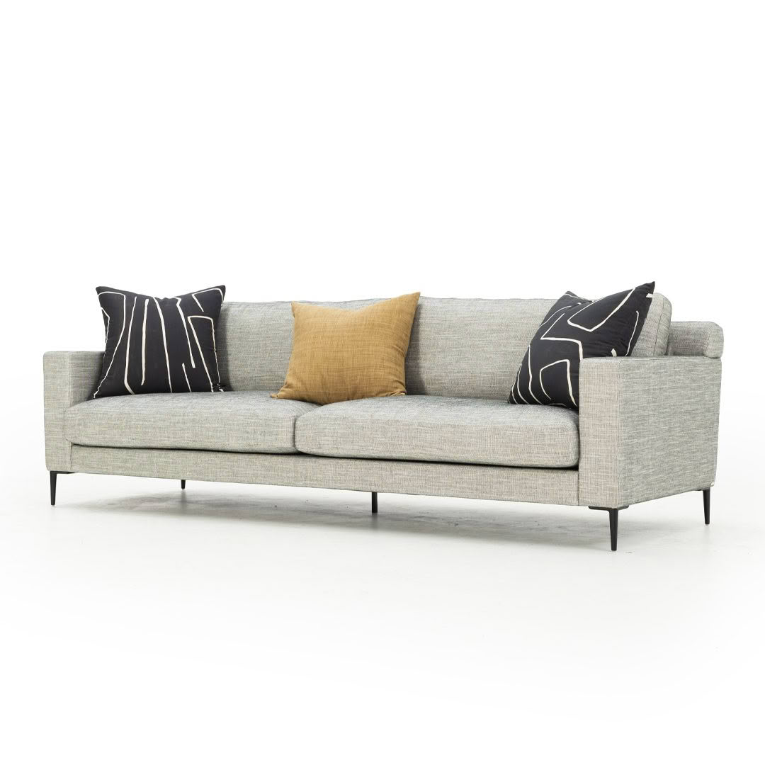 Modern gray sofa with three decorative pillows
