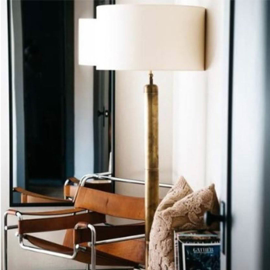 Elegant floor lamp beside modern leather chair