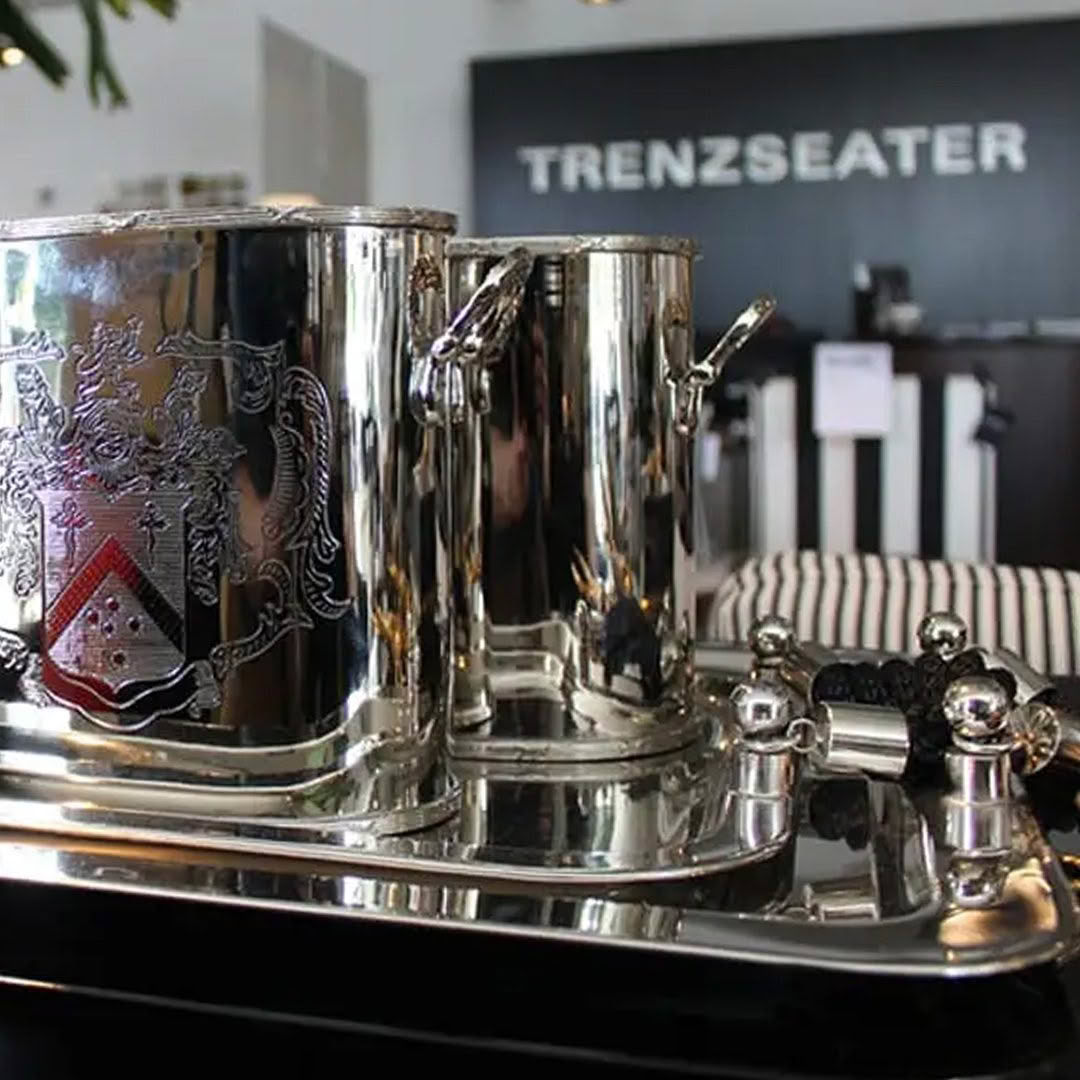 Elegant silver tea set on display at Trenzseater