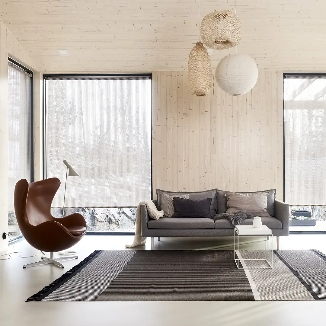 Modern winter living room with stylish furniture and large window