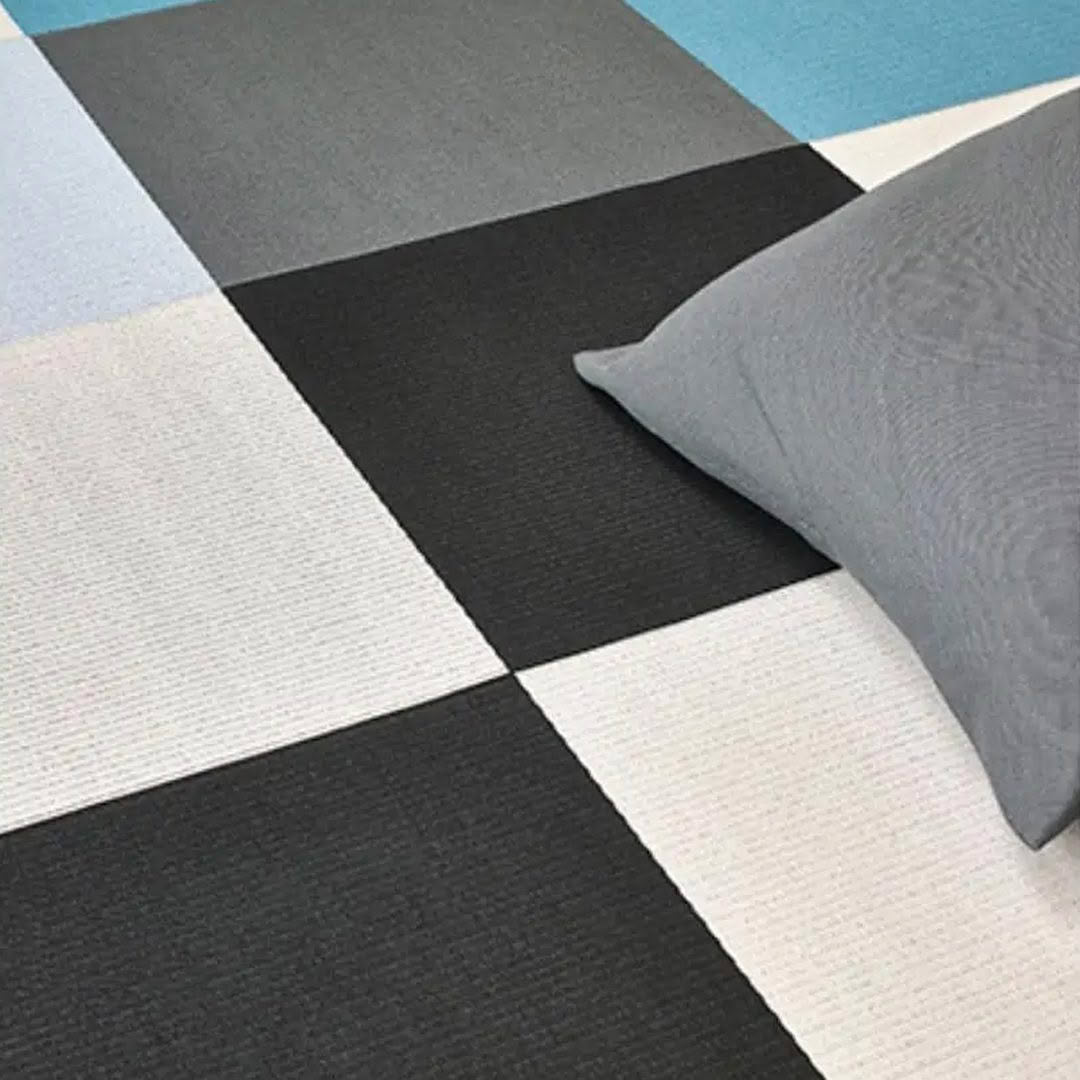 Gray and black patterned rug with blue accent