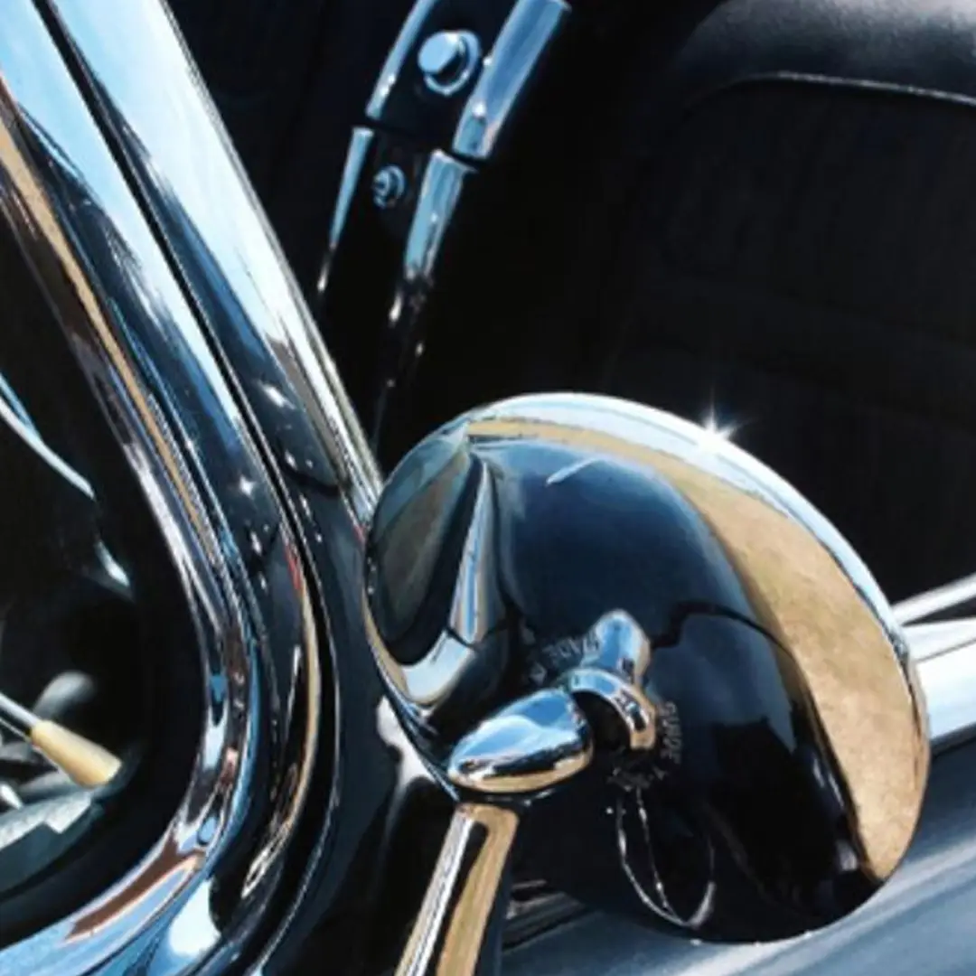 Close-up of shiny classic car side mirror