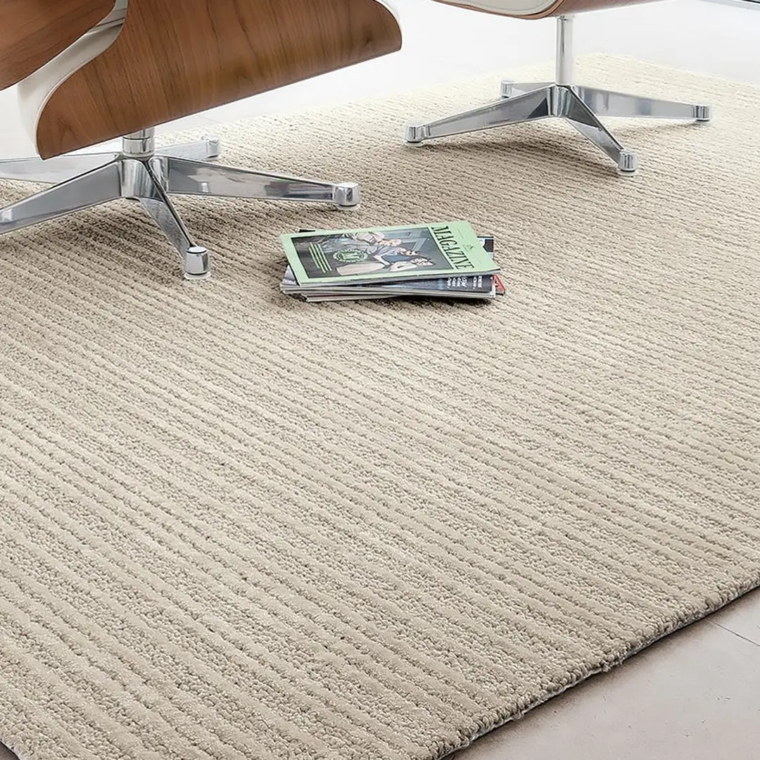 Beige textured rug under modern chair with magazine