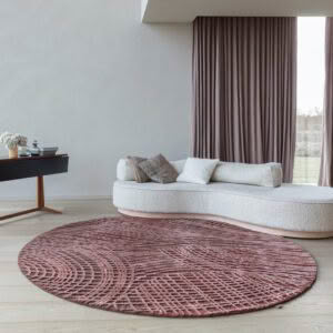 Modern interior with sofa, round rug, and large window.