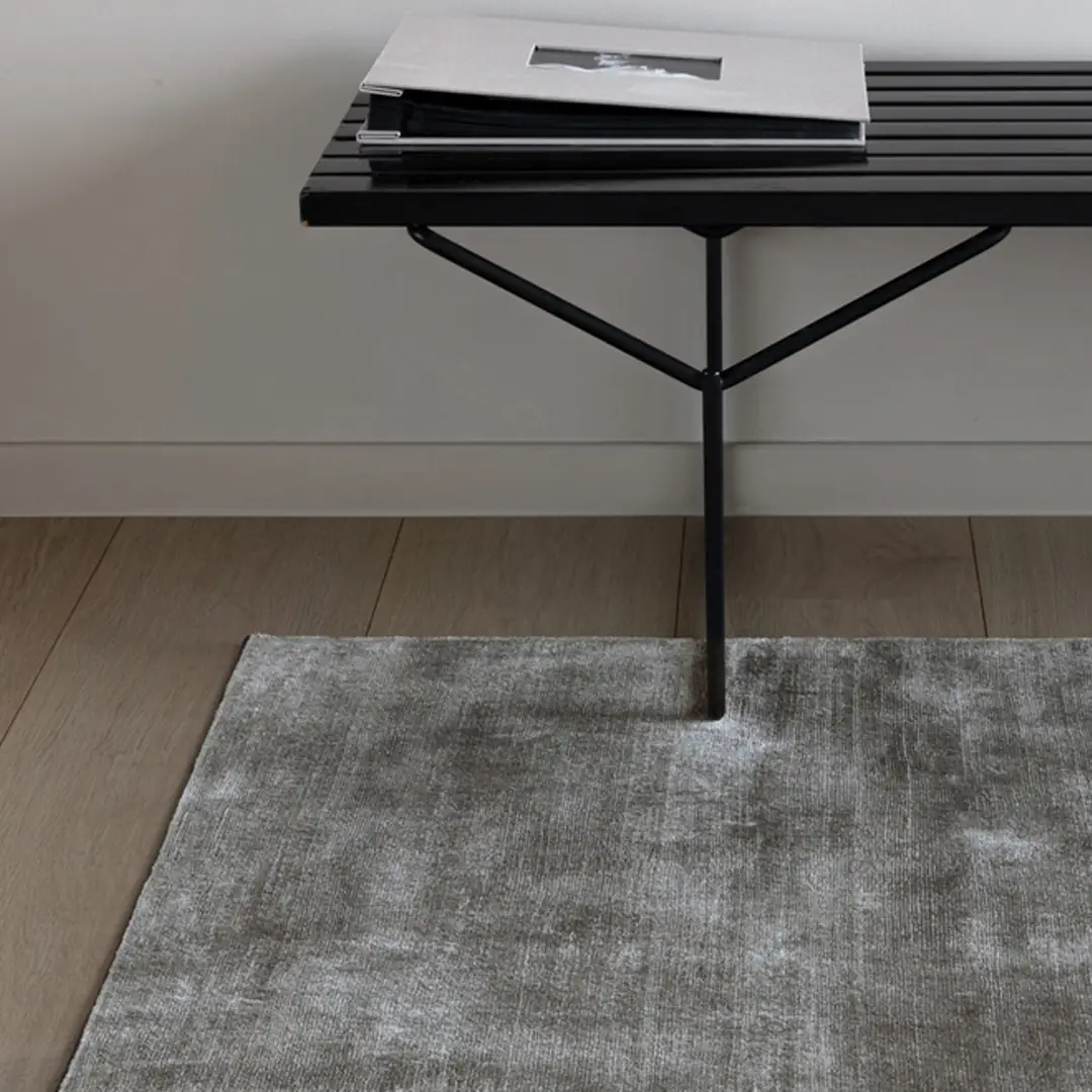Minimalist black metal bench with stacked books on top