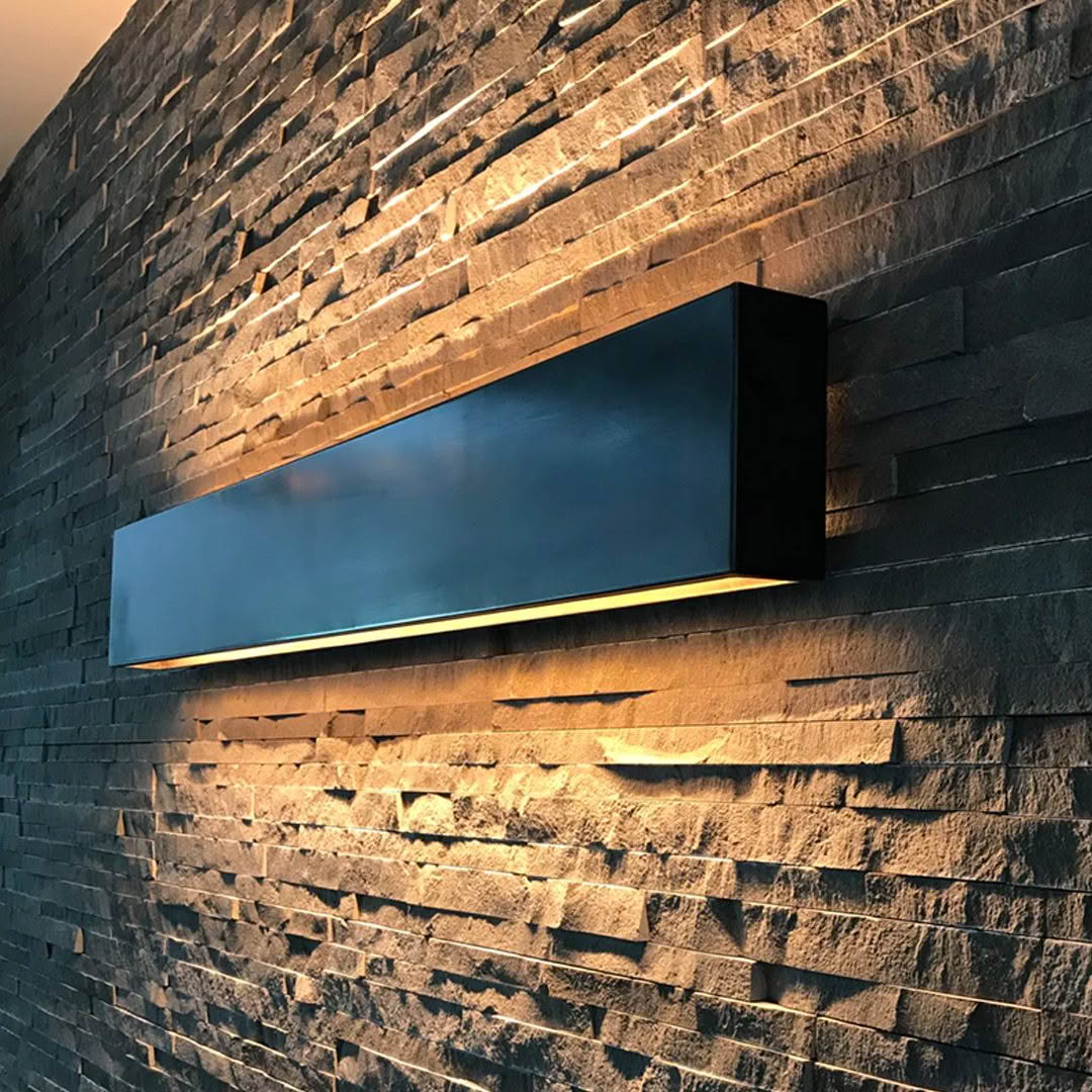 Modern wall-mounted light on textured stone wall