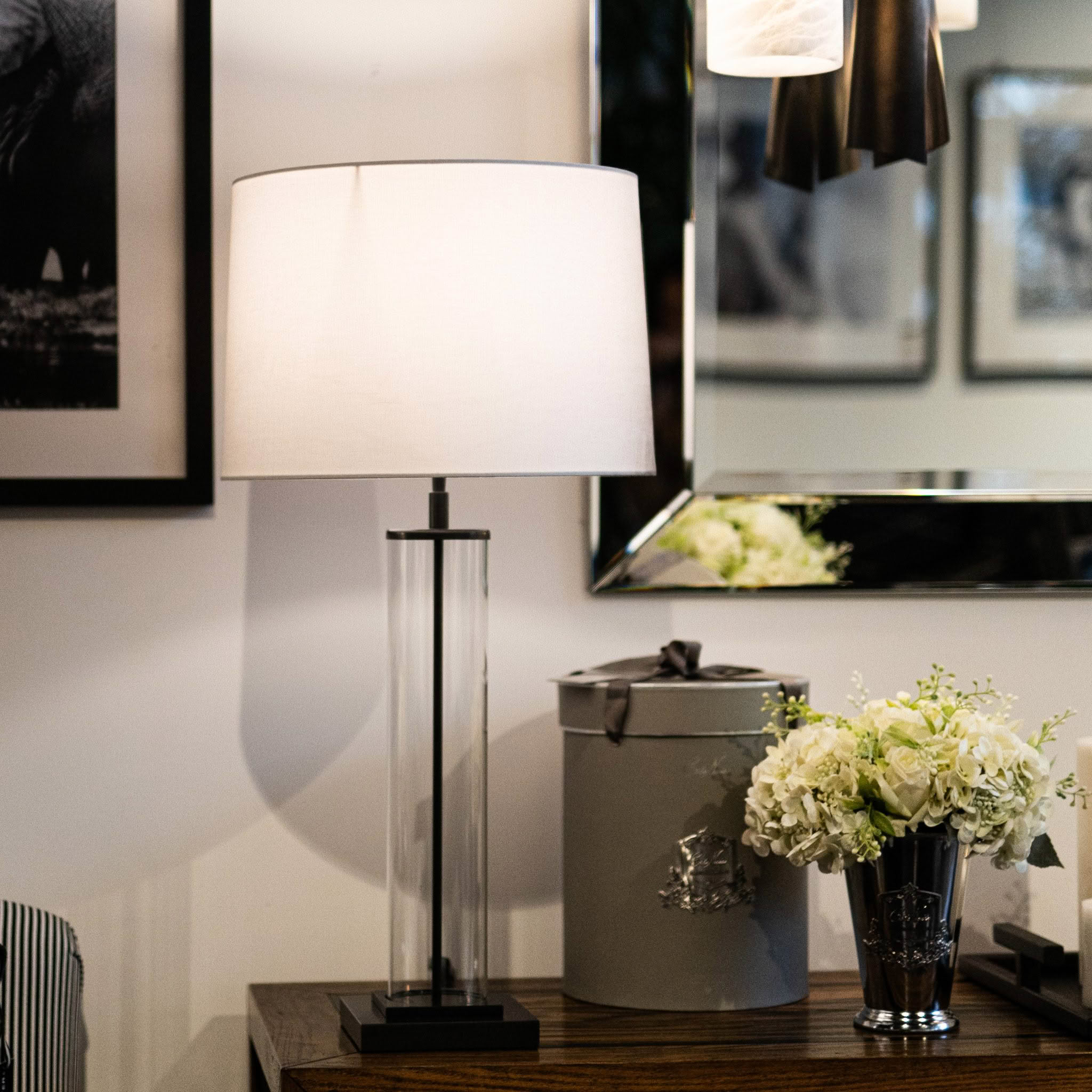 Elegant table lamp and floral arrangement in stylish room