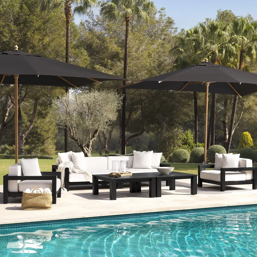 Luxury poolside patio furniture in a lush garden setting