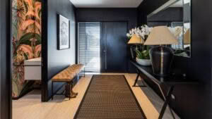 Stylish entryway with tropical wallpaper and modern decor