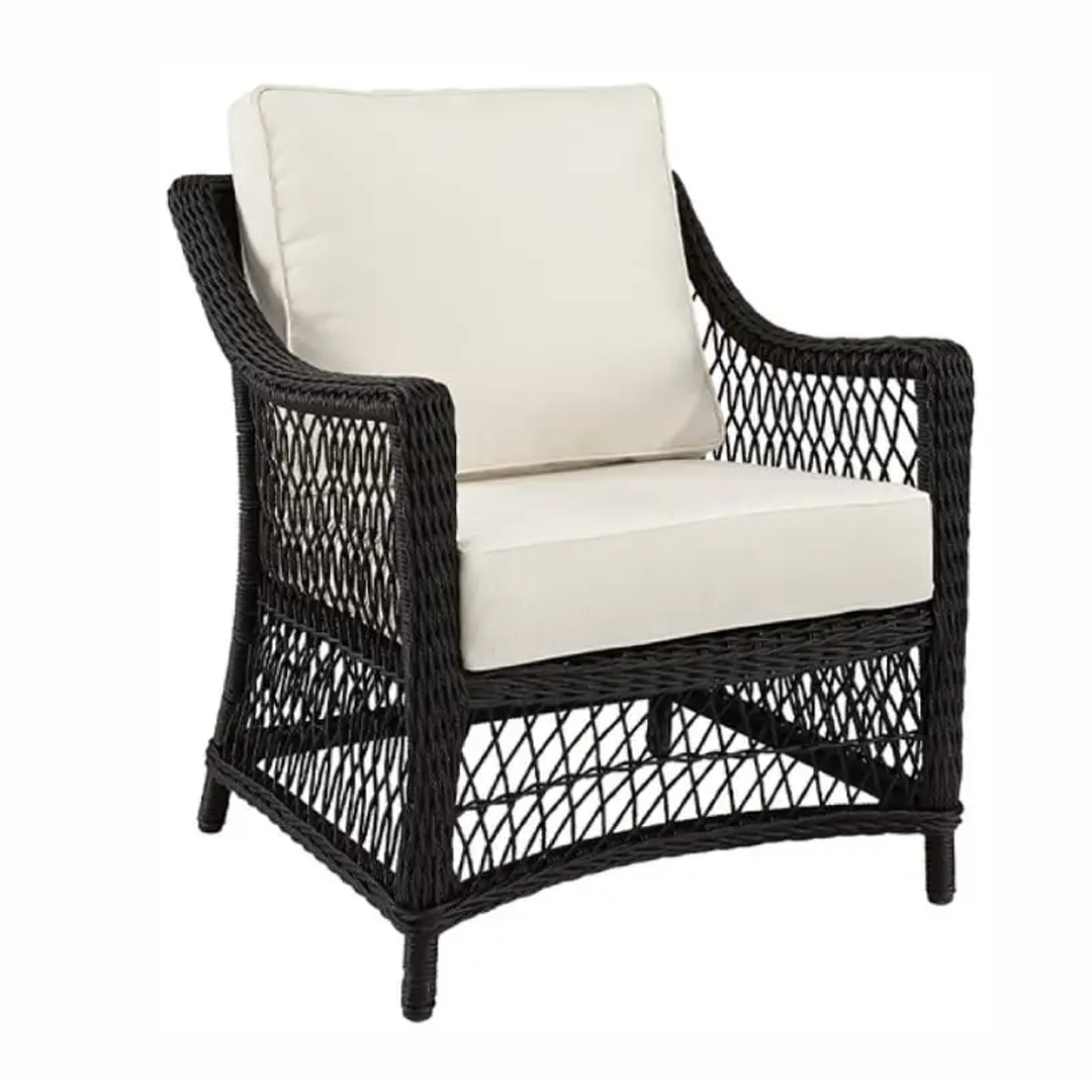 Black wicker chair with white cushions