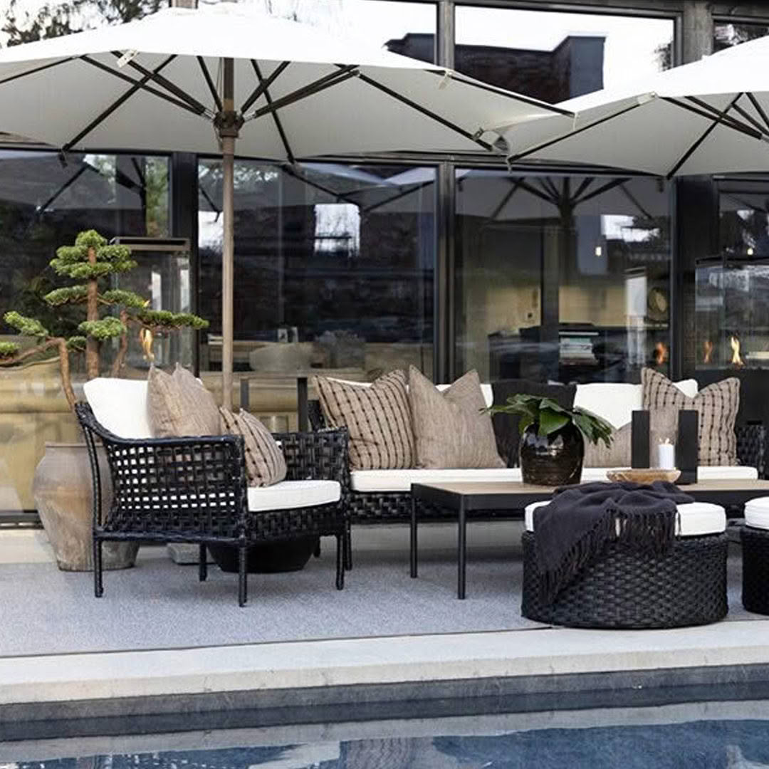 Modern outdoor poolside furniture setup with umbrellas