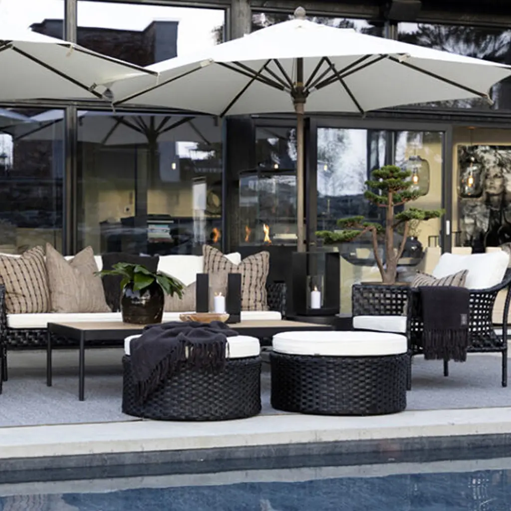 Luxurious poolside patio seating with umbrellas and fireplace