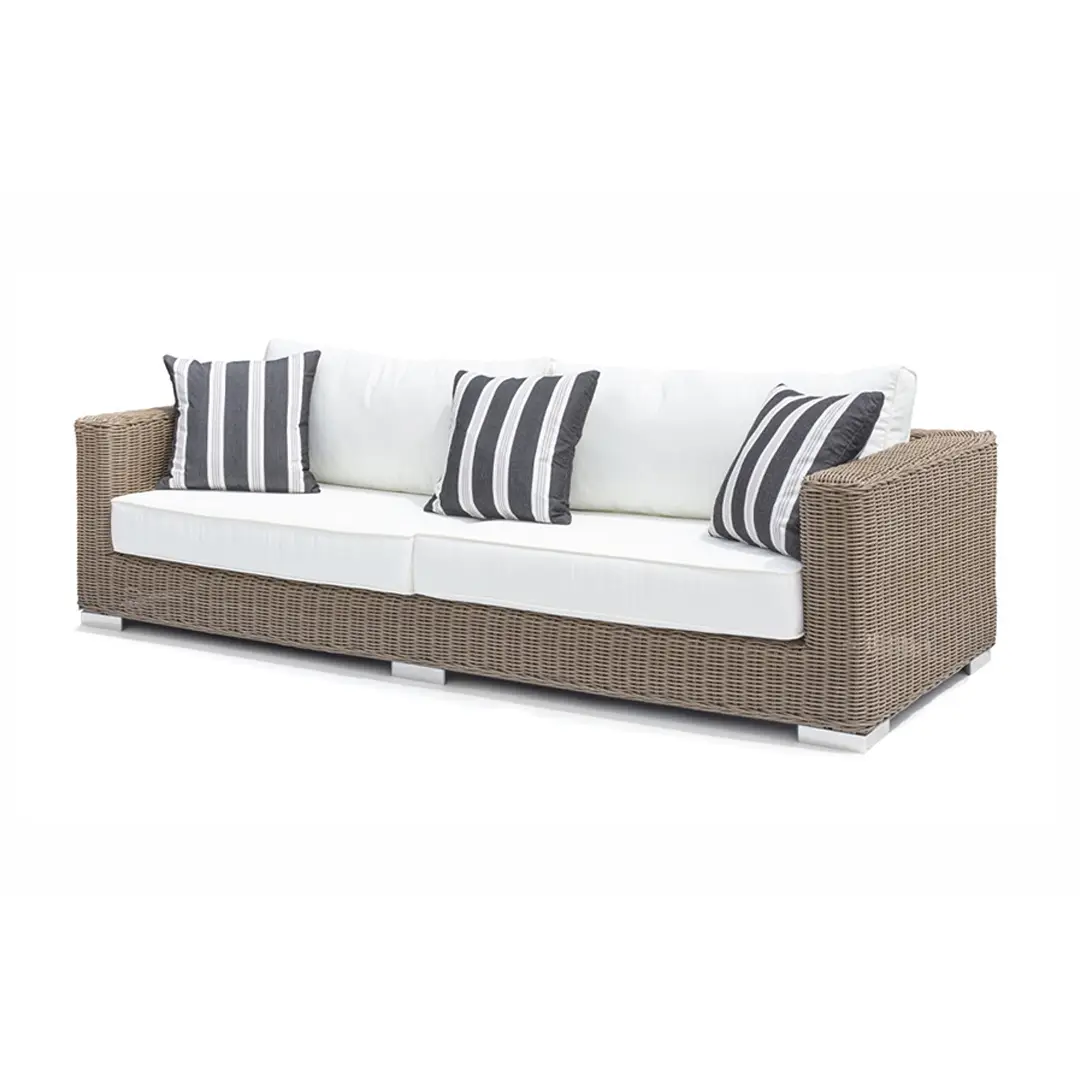Modern wicker sofa with white cushions and striped pillows