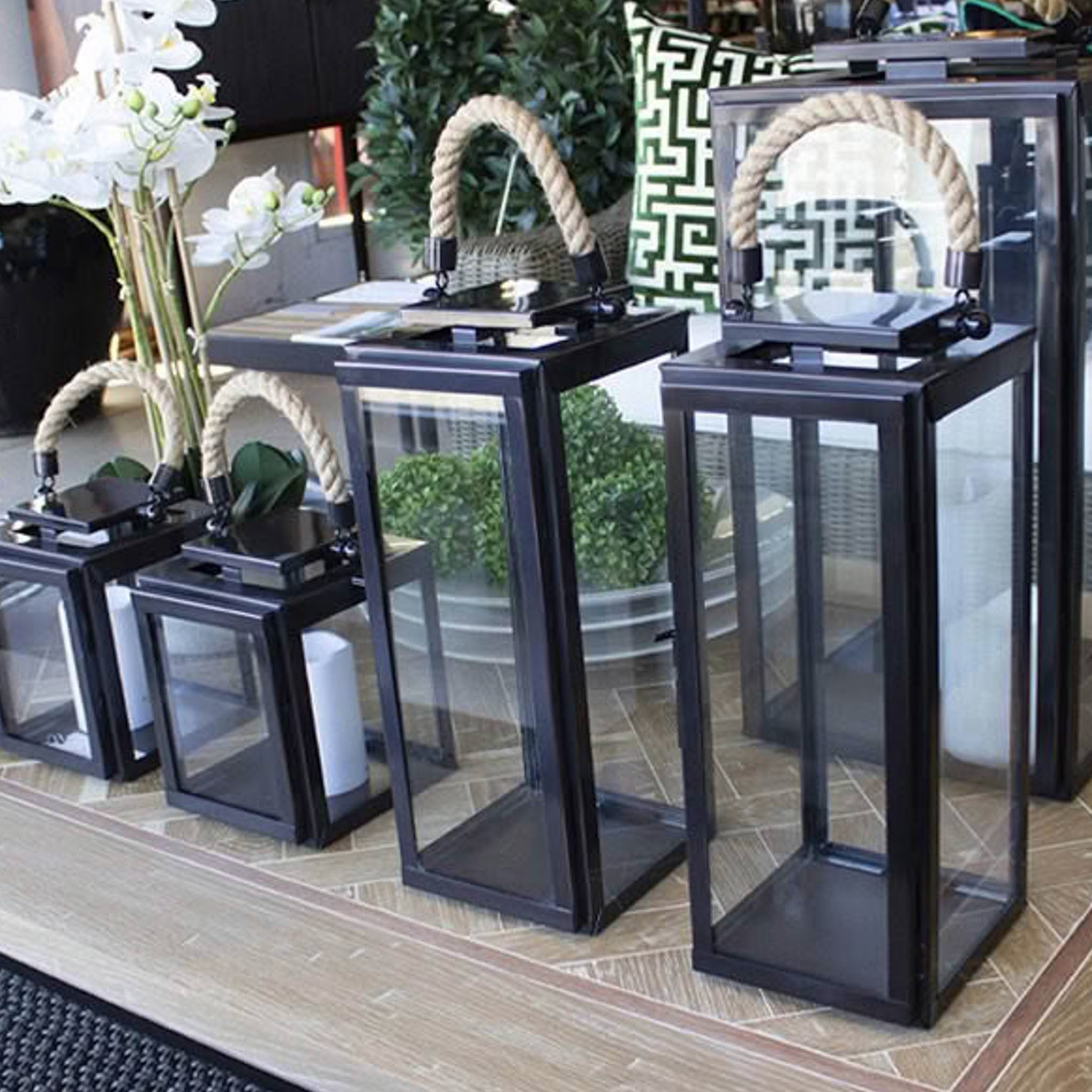 Variety of modern lanterns with rope handles on display