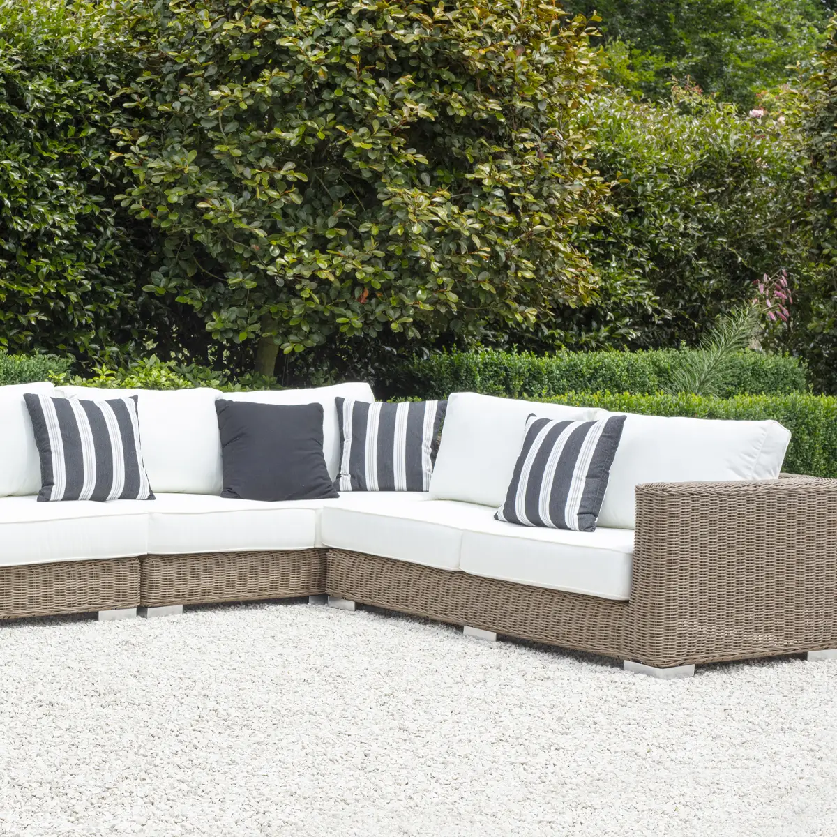 Wicker sectional sofa with cushions in a garden setting