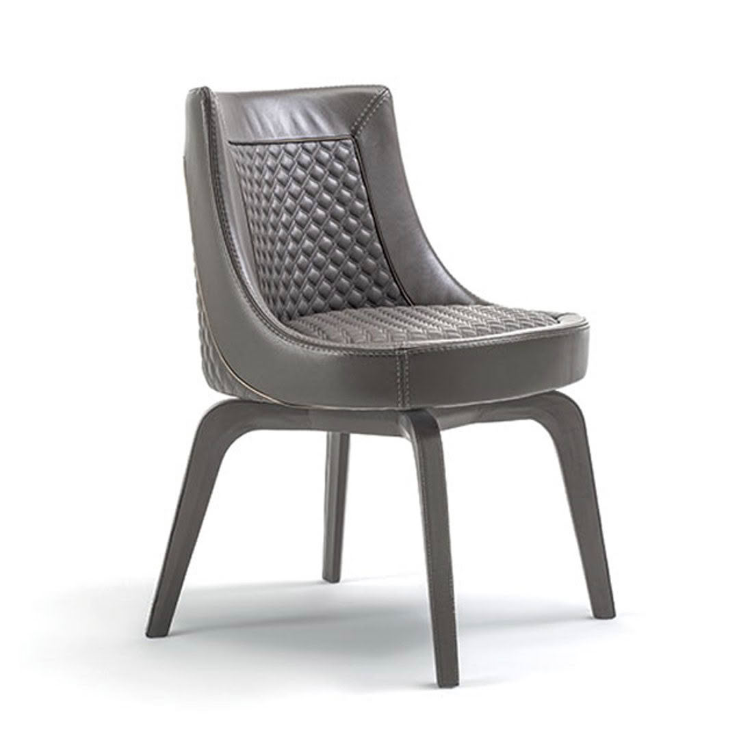 Elegant grey quilted leather chair on slim legs