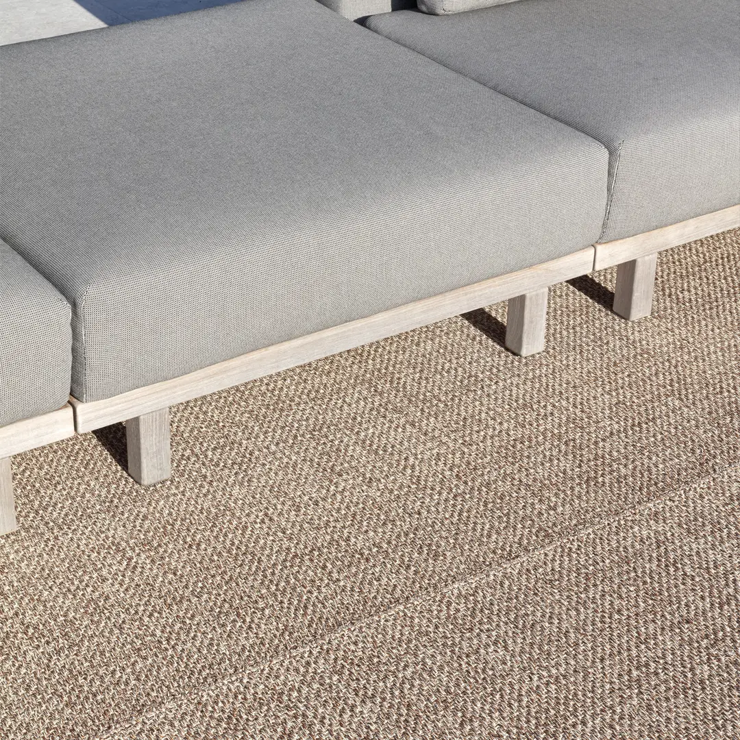 Gray outdoor sofa on textured beige rug