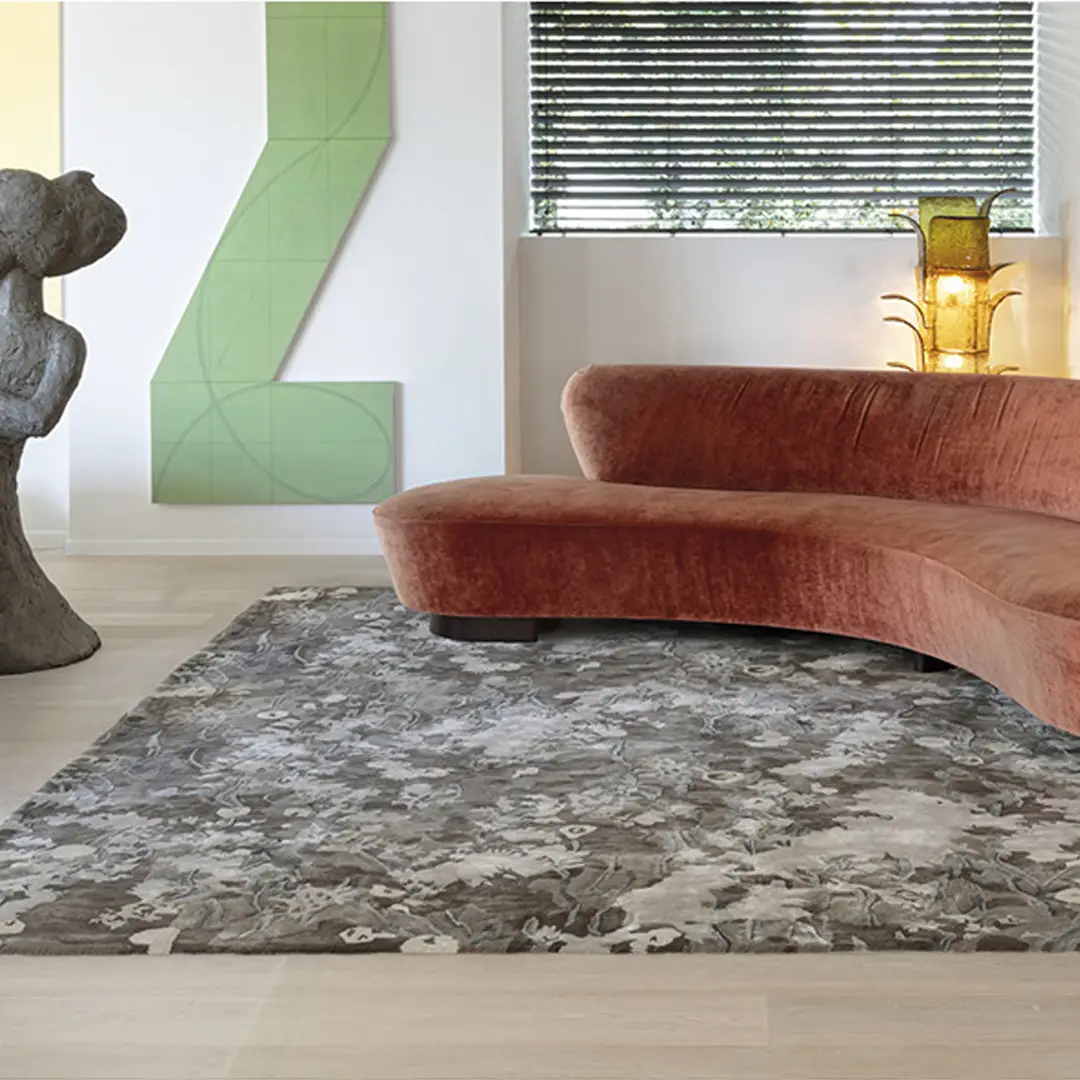 Modern living room with pink velvet sofa and statues