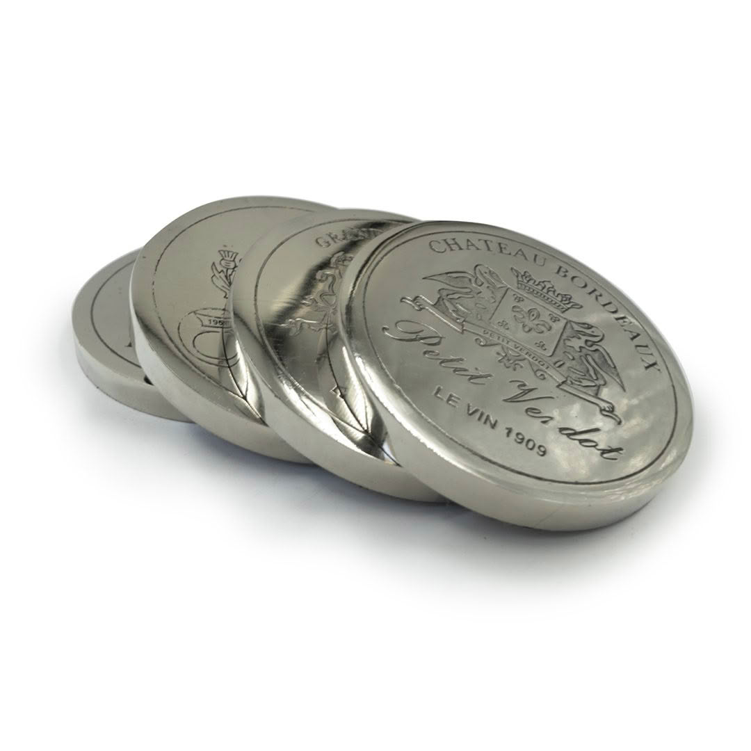 Stacked Chateau Mouton silver wine tokens.