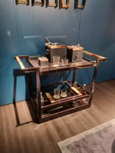 Elegant wooden bar cart with glassware and drinks