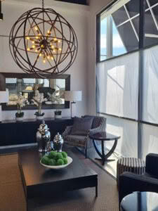 Elegant lounge with orb chandelier and stylish seating arrangement