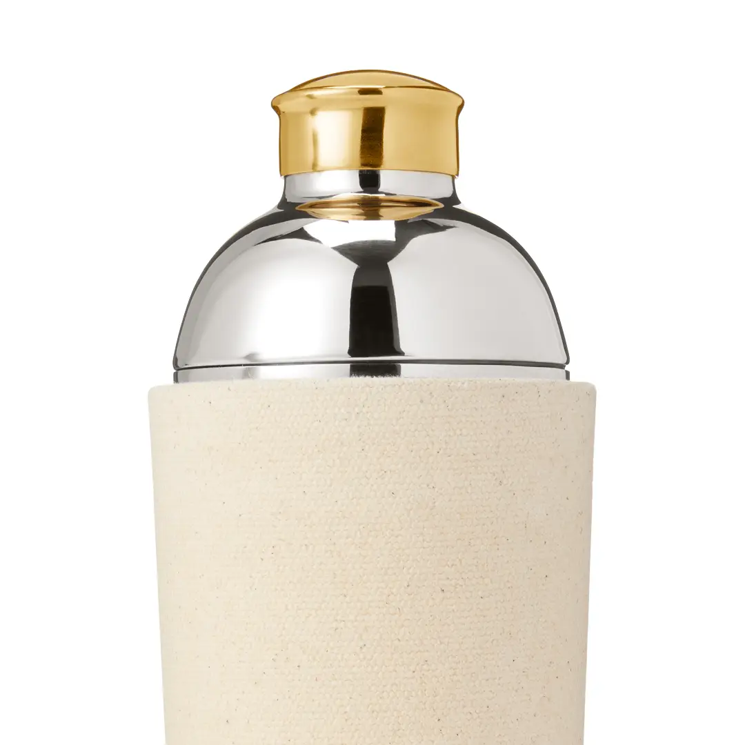 Gold and silver perfume bottle on cream background