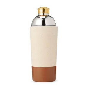 Elegant beige cocktail shaker with golden cap