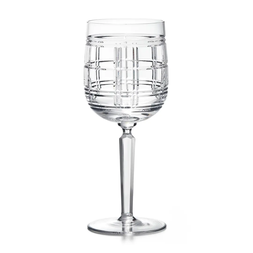 Elegant clear glass wine goblet with pattern.