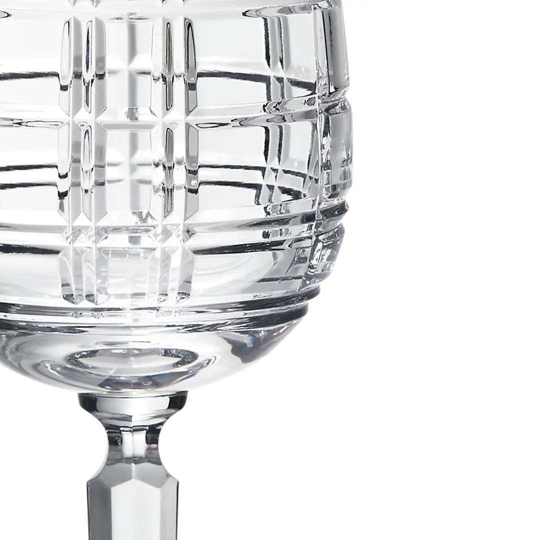 Close-up of textured glass goblet against white background