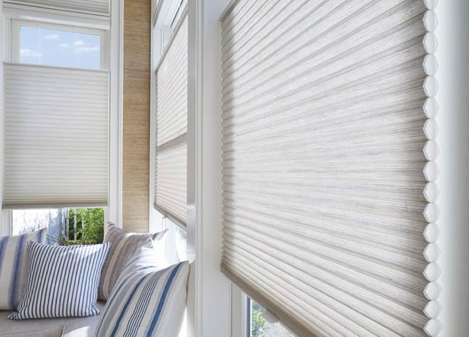 Sunlit room with modern window blinds and striped cushions