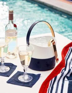 Poolside wine setup with cooler and glasses