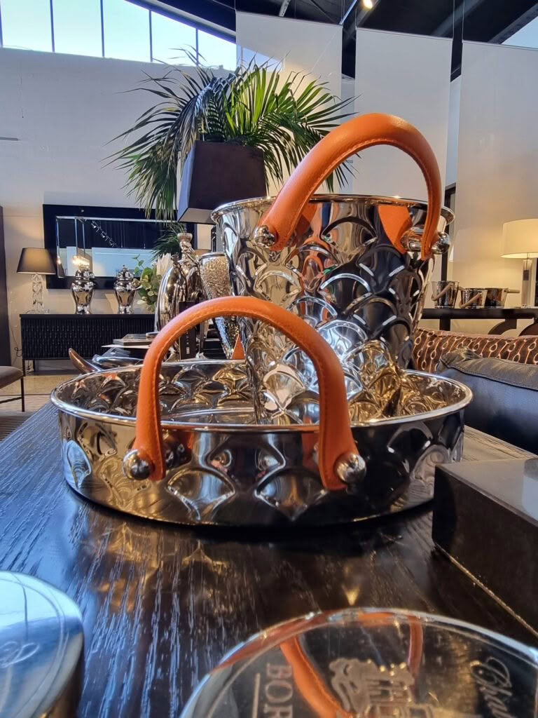 Silver tray with orange handles in modern decor setting