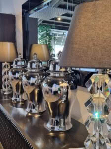 Modern silver urns and lamps in stylish interior store