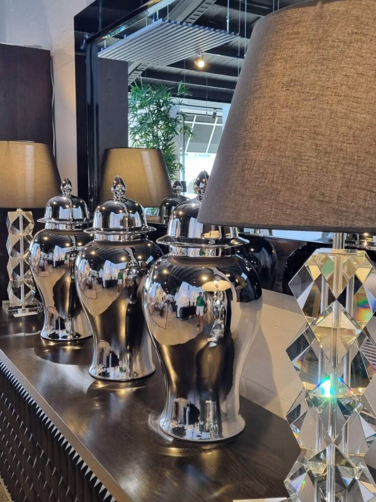 Modern silver urns and lamps in stylish interior store