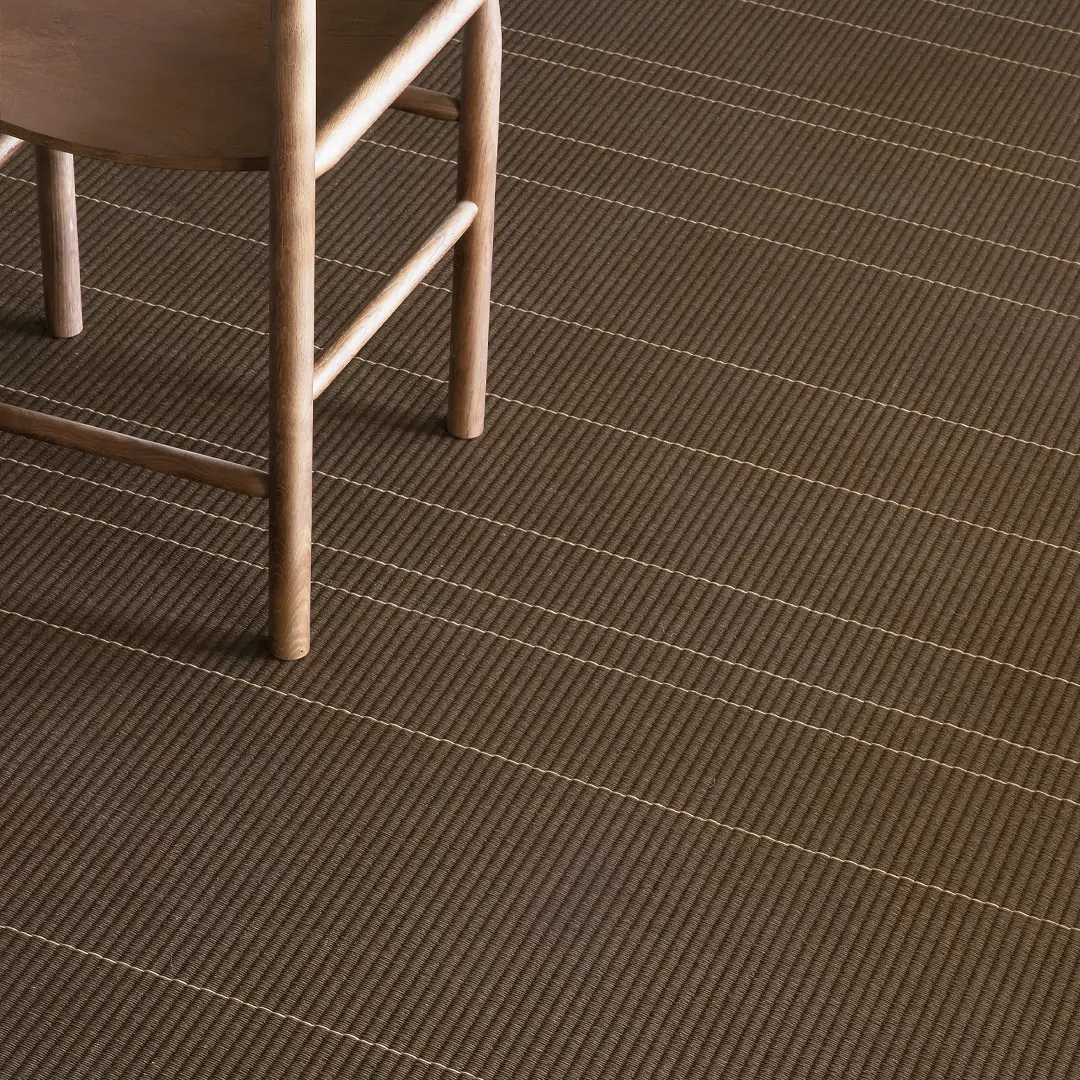 Wooden chair on textured brown striped carpet