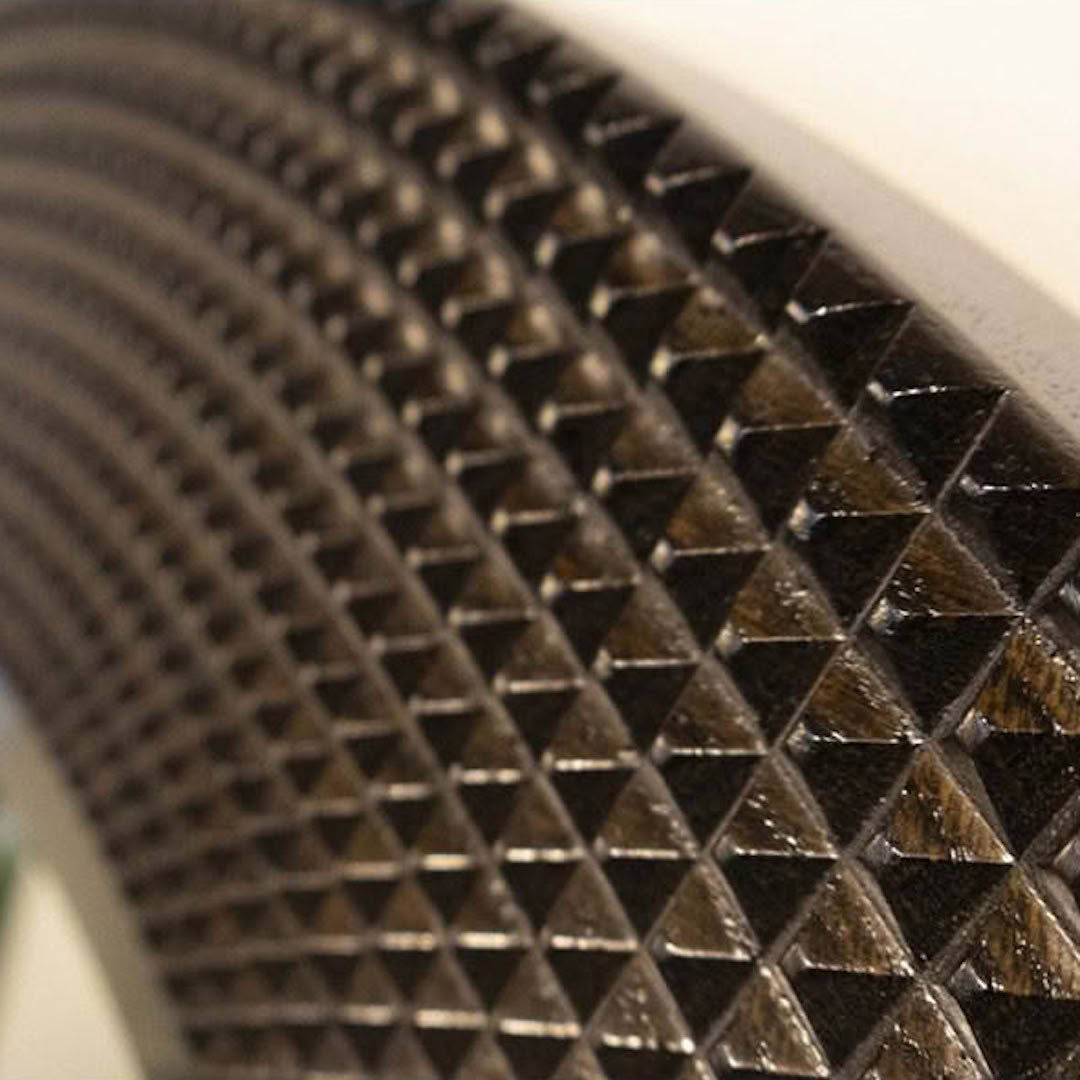 Close-up of textured metal surface with diamond pattern