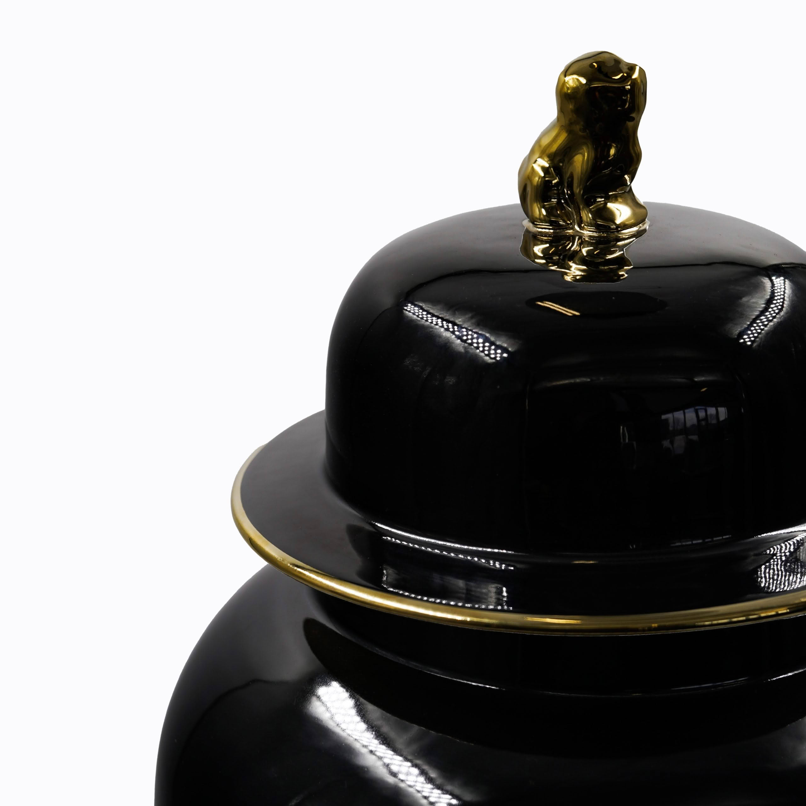 Black ceramic kettle with golden elephant lid