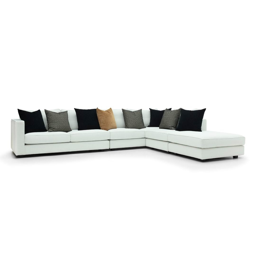 Modern white sectional sofa with decorative pillows