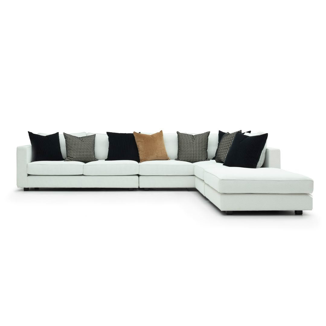 Modern white sectional sofa with decorative pillows
