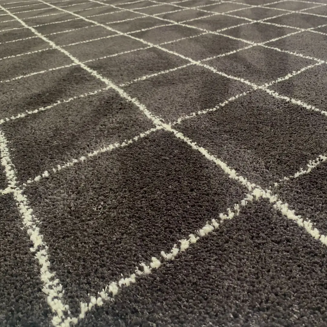 Close-up of patterned dark gray carpet