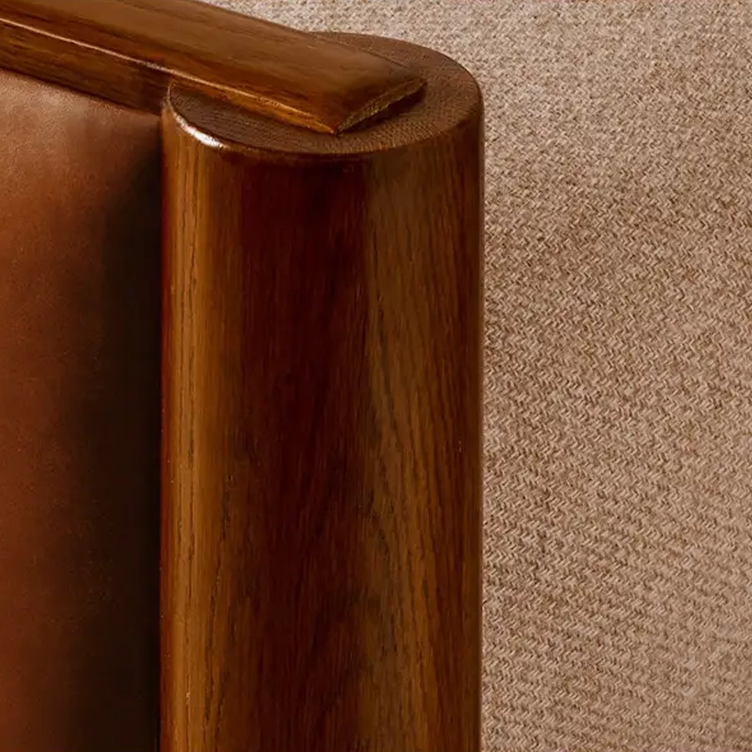 Shelter-Point-Bed Close-up of wooden armrest on brown leather chair