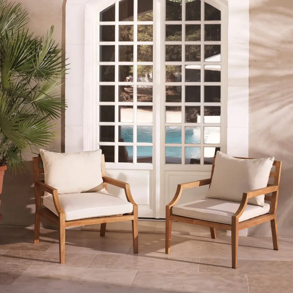 Wooden chairs by poolside patio doors