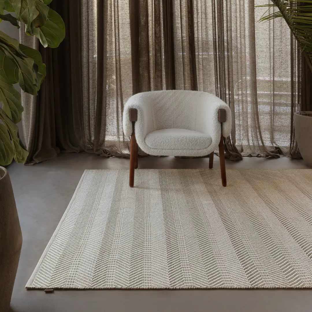 Lakeside_rug Modern white chair on textured rug in elegant room